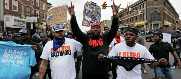 A man who calls himself Goldie Loc, center left, walks with a man who calls himself Wolfe, center, right, celebrating on Friday, May 1, 2015. A man who calls himself Goldie Loc, center left, walks with a man who calls himself Wolfe, center, right, celebrating on Friday, May 1, 2015. - Sputnik International