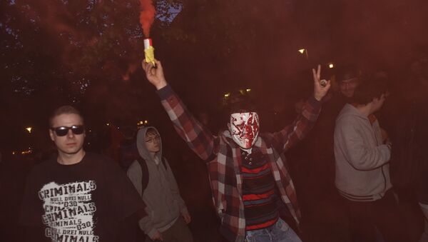 A masked protester lights a smoke-bomb during the 'Revolutionary' May Day demonstration in Berlin on May 1, 2015. - Sputnik International