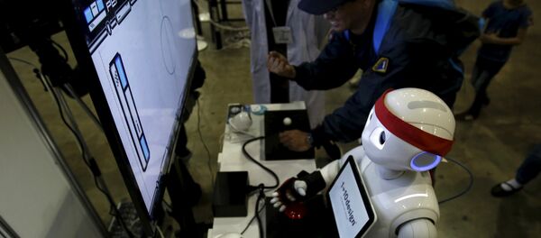 SoftBank Corp's humanoid robot named Pepper plays a video game against a visitor at a booth during Niconico Chokaigi 2015 in Makuhari, east of Tokyo, Japan April 26, 2015. SoftBank Corp's humanoid robot named Pepper plays a video game against a visitor at a booth during Niconico Chokaigi 2015 in Makuhari, east of Tokyo, Japan April 26, 2015. - Sputnik International