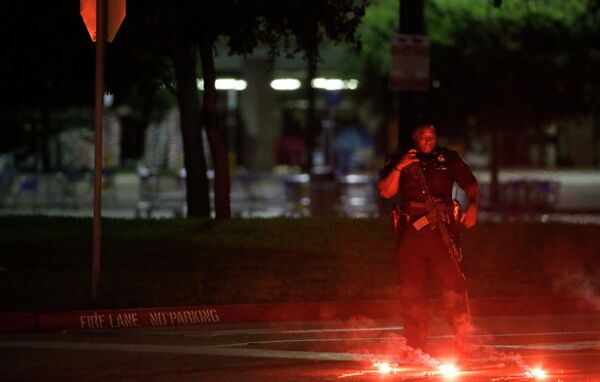 An armed police officer stands guard at a parking lot near the Curtis Culwell Center An armed police officer stands guard at a parking lot near the Curtis Culwell Center - Sputnik International