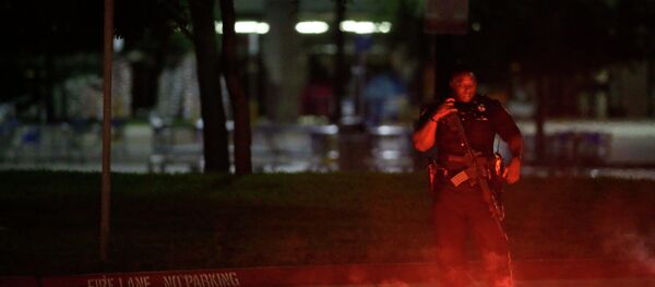An armed police officer stands guard at a parking lot near the Curtis Culwell Center An armed police officer stands guard at a parking lot near the Curtis Culwell Center - Sputnik International