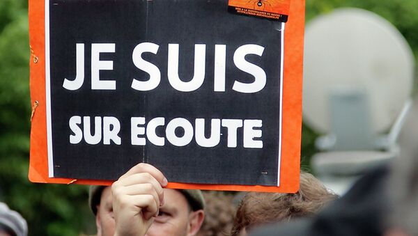 A demonstrator holds a placard that reads: I am on Record, during a gathering at Invalides, Paris, to protest against the emergency government surveillance law, Monday, May 4, 2015. - Sputnik International