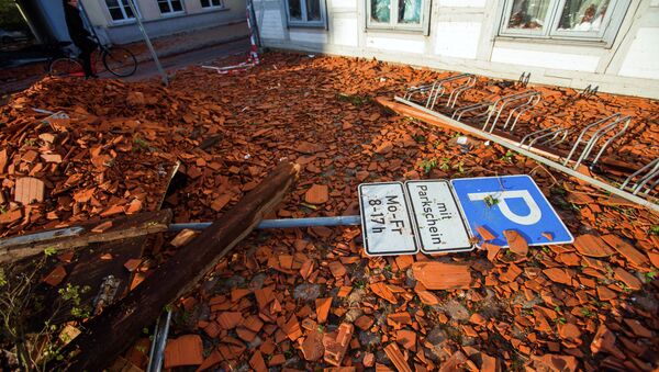 A parking sign lays amidst tiles blown away from roofs by a tornado on a street in Buetzow, northeastern Germany, on May 6, 2015. - Sputnik International
