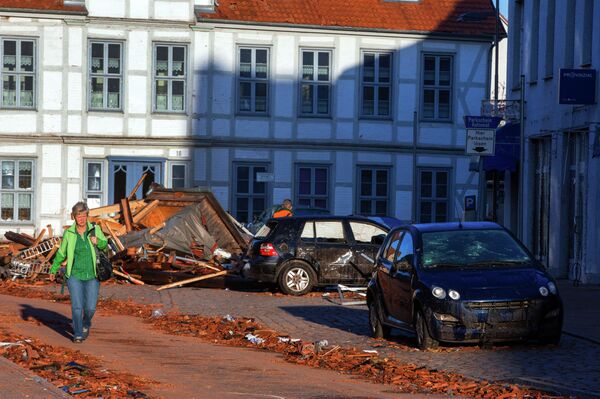 A woman walks past debris of houses destroyed by a tornado on a street in Buetzow, northeastern Germany, on May 6, 2015 A woman walks past debris of houses destroyed by a tornado on a street in Buetzow, northeastern Germany, on May 6, 2015 - Sputnik International