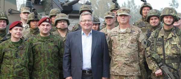 Poland’s President Bronislaw Komorowski stands with troops from Poland and other nations in Bemowo Piskie near Orzysz, in northeastern Poland Poland’s President Bronislaw Komorowski stands with troops from Poland and other nations in Bemowo Piskie near Orzysz, in northeastern Poland - Sputnik International