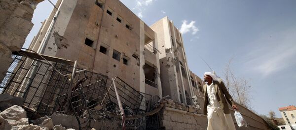 A man looks at a school destroyed by an air strike as he flees his home in Sanaa April 28, 2015 A man looks at a school destroyed by an air strike as he flees his home in Sanaa April 28, 2015 - Sputnik International