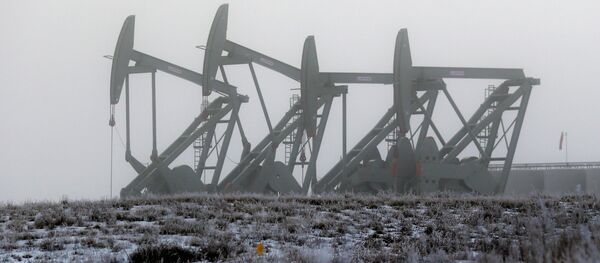 Oil pump jacks work in unison on a foggy morning in Williston, N.D Oil pump jacks work in unison on a foggy morning in Williston, N.D - Sputnik International