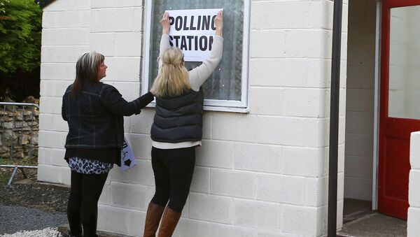 Electoral workers put up a sign in the window of a building being used as a polling station in Doncaster, northern England, May 7, 2015 - Sputnik International
