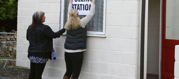 Electoral workers put up a sign in the window of a building being used as a polling station in Doncaster, northern England, May 7, 2015 - Sputnik International