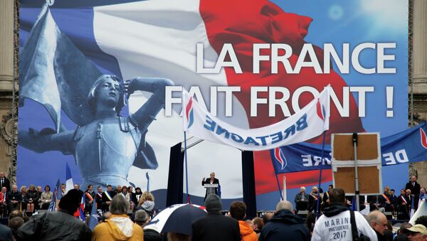 France’s far-right National Front president Marine Le Pen, center, delivers her speech at Opera Plaza during the annual May Day march, in Paris, France, Friday, May 1, 2015. - Sputnik International