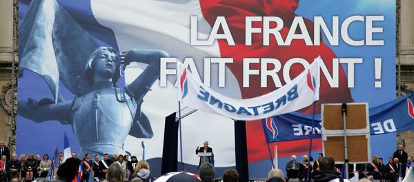 France’s far-right National Front president Marine Le Pen, center, delivers her speech at Opera Plaza during the annual May Day march, in Paris, France, Friday, May 1, 2015. - Sputnik International