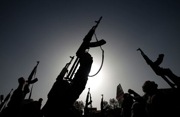 Shiite rebels known as Houthis hold up their weapons to denounce the Saudi-led airstrikes as they chant slogans during a protest in Sanaa, Yemen Shiite rebels known as Houthis hold up their weapons to denounce the Saudi-led airstrikes as they chant slogans during a protest in Sanaa, Yemen - Sputnik International