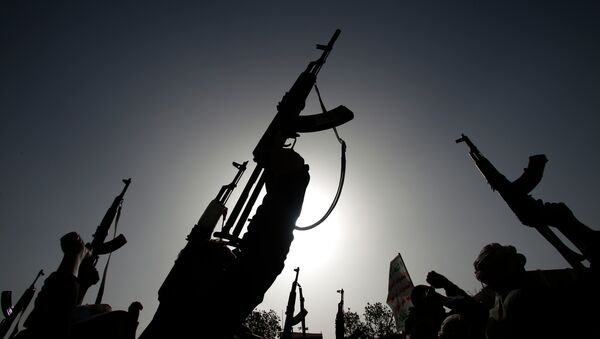 Shiite rebels known as Houthis hold up their weapons to denounce the Saudi-led airstrikes as they chant slogans during a protest in Sanaa, Yemen - Sputnik International