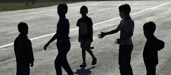 Nepalese children play near tents at a tent camp in Kathmandu, nine days after a devastating earthquake shook Nepal killing over 7,300 people and leaving tens of thousands of people homeless - Sputnik International