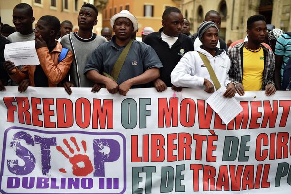Asylum seekers hold a banner asking for freedom of movement and work in Europe, during a demonstration in front of the Italian parliament in Rome, on April 23, 2015 Asylum seekers hold a banner asking for freedom of movement and work in Europe, during a demonstration in front of the Italian parliament in Rome, on April 23, 2015 - Sputnik International