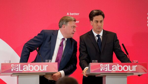 The leader of Britain's Labour Party Ed Miliband, right, listens to his party's finance minister Ed Balls during an election campaign press conference on their theme of the threat to family finances from Britain's Conservative Party in London, Wednesday, April 29, 2015 - Sputnik International