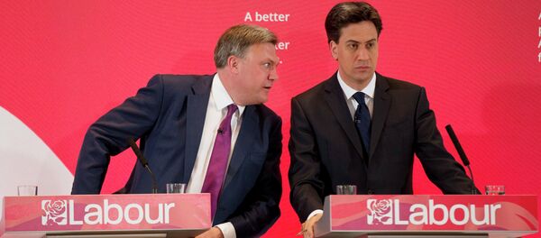 The leader of Britain's Labour Party Ed Miliband, right, listens to his party's finance minister Ed Balls during an election campaign press conference on their theme of the threat to family finances from Britain's Conservative Party in London, Wednesday, April 29, 2015 The leader of Britain's Labour Party Ed Miliband, right, listens to his party's finance minister Ed Balls during an election campaign press conference on their theme of the threat to family finances from Britain's Conservative Party in London, Wednesday, April 29, 2015 - Sputnik International