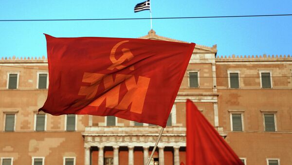A Greek Communist Party flag waves in front of the Parliament in Athens during an protest against any military action by the U.S. and its allies against Syria, Thursday Aug. 29, 2013 - Sputnik International