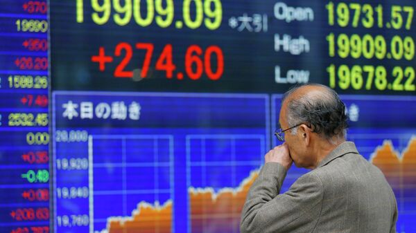 A man looks at an electronic stock indicator of a securities firm in Tokyo  - Sputnik International