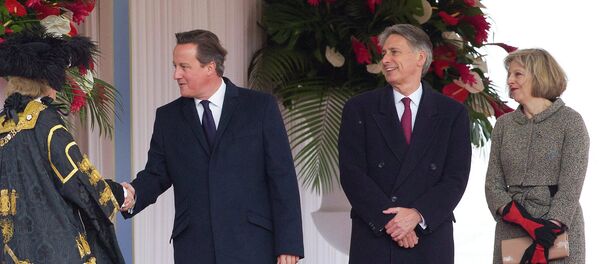 British Prime Minister David Cameron (2L), Foreign Secretary Philip Hammond (C) and Home Secretary Theresa May (R) British Prime Minister David Cameron (2L), Foreign Secretary Philip Hammond (C) and Home Secretary Theresa May (R) - Sputnik International