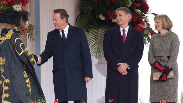 British Prime Minister David Cameron (2L), Foreign Secretary Philip Hammond (C) and Home Secretary Theresa May (R) - Sputnik International