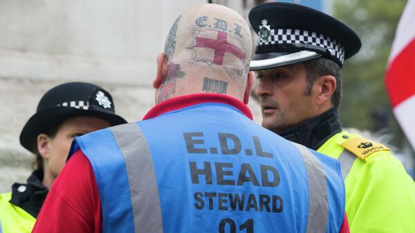 A supporter of the far-right English Defence League (EDL) speaks with police during a march in London on September 20, 2014 - Sputnik International