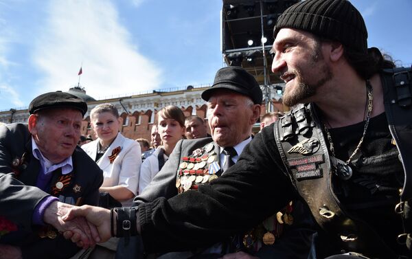 Alexander Zaldostanov also known as Khirurg (The Surgeon), leader of the Night Wolves bikers' club, shakes hands with a veteran before the Victory Day military parade at Red Square in Moscow on May 9, 2015 - Sputnik International