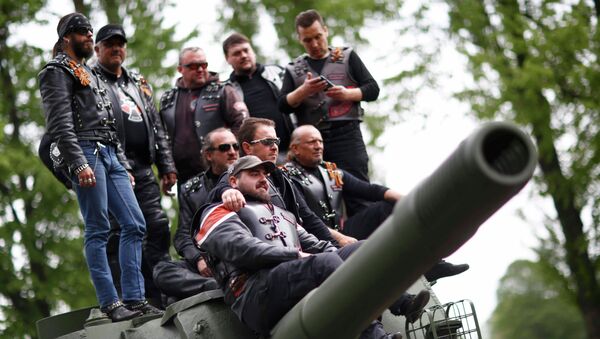 Members of the motorcycle group called Night Wolves coming from Russia, Macedonia and Bulgaria pose for a picture on top of a Red Army tank at the German-Russian museum Berlin-Karlshorst in Berlin, Germany, May 8, 2015 - Sputnik International