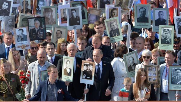 The president of the Russian Federation Vladimir Putin (in the center) during procession of Regional patriotic public organization Immortal Regiment Moscow along the Red Square - Sputnik International