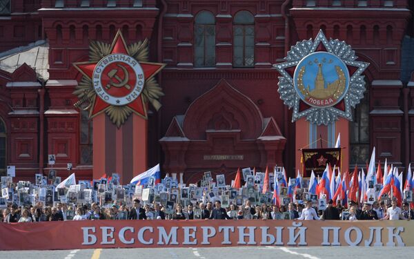 March of Immortal Regiment on Red Square. Pictured on the wall of the State Historical Museum is the Order of the Patriotic War (left) and the Order of Victory (right) - Sputnik International