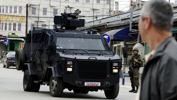 A Macedonian police armoured personnel carrier drives past premises in Kumanovo, north of the capital Skopje, Macedonia May 9, 2015 - Sputnik International