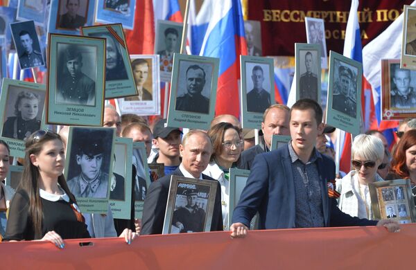 Russian President Vladimir Putin participates in march of Immortal Regiment in downtown Moscow Russian President Vladimir Putin participates in march of Immortal Regiment in downtown Moscow - Sputnik International