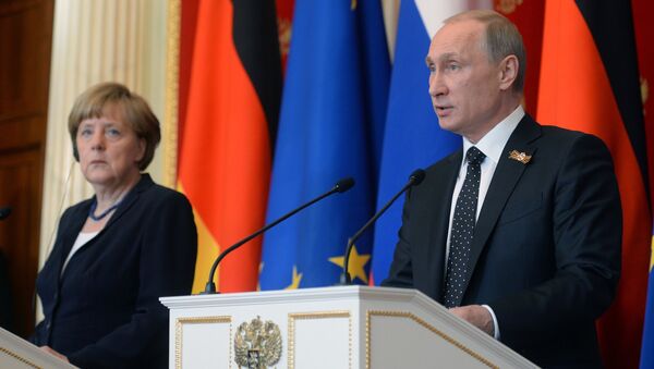 Russian President Vladimir Putin during a joint press conference with German Chancellor Angela Merkel in Moscow on May 10, 2015. - Sputnik International