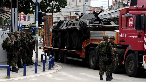 A truck loaded with a damaged armored police vehicle passes near police check point in Kumanovo, Macedonia - Sputnik International