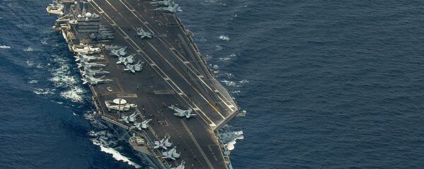 Two F/A-18 Super Hornets and two Royal Malaysian Air Force Mig 29 Fulcrum fly in formation above aircraft carrier USS Carl Vinson - Sputnik International