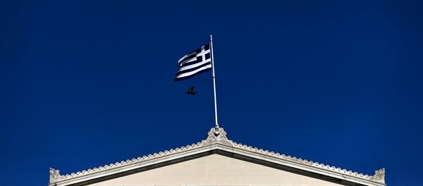 A Greek national flag flutters atop the parliament building in Athens A Greek national flag flutters atop the parliament building in Athens - Sputnik International