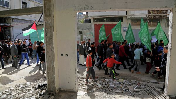 Palestinian Hamas supporters march with green Hamas and national flags in Beit Hanoun, northern Gaza Strip. - Sputnik International