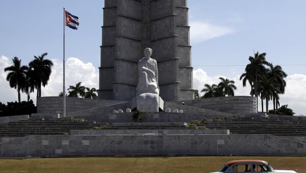 A car drives past the memorial monument of Cuban Independence hero Jose Marti in Havana's Revolution Square - Sputnik International