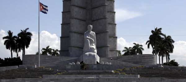 A car drives past the memorial monument of Cuban Independence hero Jose Marti in Havana's Revolution Square - Sputnik International
