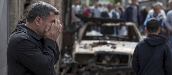 A man reacts next to a burnt out vehicle in Kumanovo, Macedonia A man reacts next to a burnt out vehicle in Kumanovo, Macedonia - Sputnik International