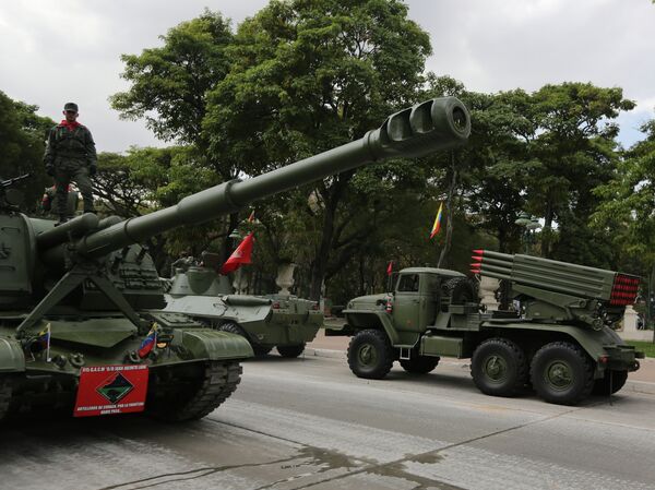 A soldier stands on an armored vehicle after participating in a military parade commemorating the one year anniversary of the death of Venezuela's former President Hugo Chavez in Caracas, Venezuela, Wednesday, March 5, 2014 A soldier stands on an armored vehicle after participating in a military parade commemorating the one year anniversary of the death of Venezuela's former President Hugo Chavez in Caracas, Venezuela, Wednesday, March 5, 2014 - Sputnik International