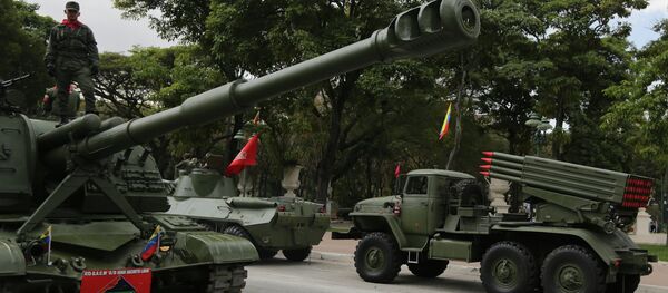 A soldier stands on an armored vehicle after participating in a military parade commemorating the one year anniversary of the death of Venezuela's former President Hugo Chavez in Caracas, Venezuela, Wednesday, March 5, 2014 A soldier stands on an armored vehicle after participating in a military parade commemorating the one year anniversary of the death of Venezuela's former President Hugo Chavez in Caracas, Venezuela, Wednesday, March 5, 2014 - Sputnik International