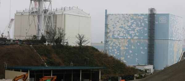 A part of the roof of a building covering the Unit 1 reactor, left, is seen removed at the Fukushima Dai-ichi nuclear power plant in Okuma, Fukushima prefecture, northeastern Japan, Wednesday, Nov. 12, 2014 - Sputnik International