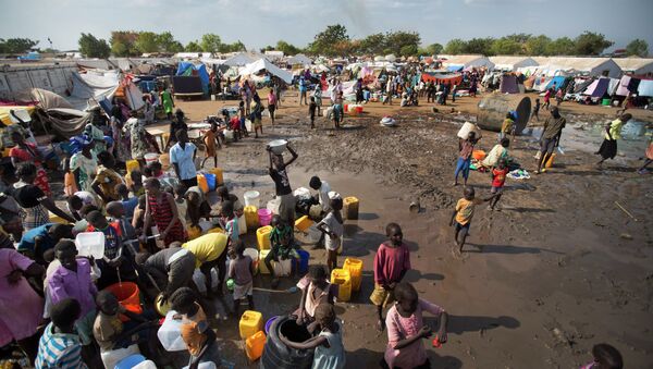 In this file photo of Sunday Dec. 29, 2013 file photo, displaced people gather around a water truck to fill containers at a United Nations compound which has become home to thousands of people displaced by the recent fighting, in the capital Juba, South Sudan - Sputnik International