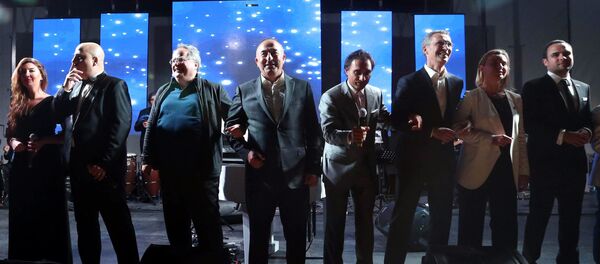 Secretary General of NATO, Jens Stoltenberg, third right, Turkish Foreign Minister Mevlut Cavusoglu, center, Greek Foreign Minister Nikos Kotzias, third left, EU High representative for foreign policy Federica Mogherini, second right, and other NATO officials dance to We are the world after a dinner during the NATO Foreign Ministers' conference in Antalya, Turkey, Wednesday, May 13, 2015 Secretary General of NATO, Jens Stoltenberg, third right, Turkish Foreign Minister Mevlut Cavusoglu, center, Greek Foreign Minister Nikos Kotzias, third left, EU High representative for foreign policy Federica Mogherini, second right, and other NATO officials dance to We are the world after a dinner during the NATO Foreign Ministers' conference in Antalya, Turkey, Wednesday, May 13, 2015 - Sputnik International