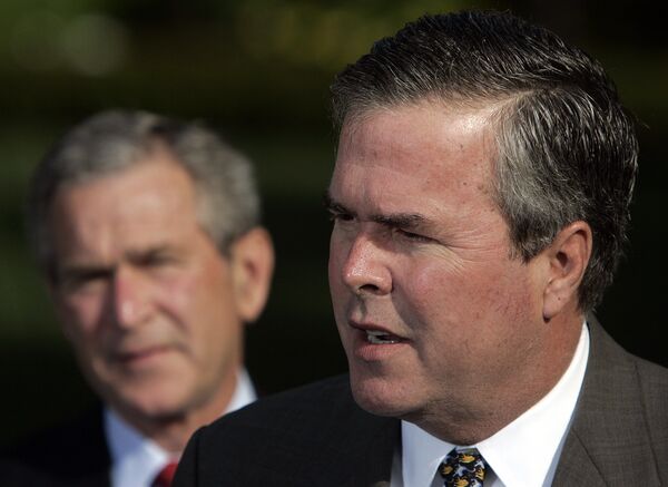 George W. Bush (L) looks on as his brother Jeb Bush speaks. George W. Bush (L) looks on as his brother Jeb Bush speaks. - Sputnik International