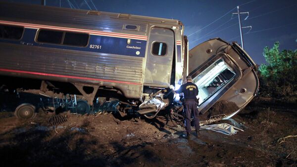 Emergency personnel work the scene of a deadly train wreck, Tuesday, May 12, 2015, in Philadelphia - Sputnik International