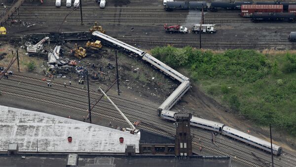 Emergency personnel work at the scene of a deadly train derailment, Wednesday, May 13, 2015, in Philadelphia - Sputnik International