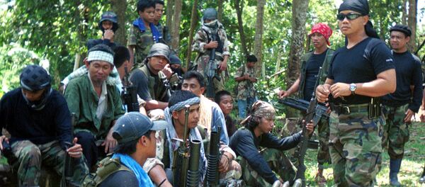 Abu Sayyaf spokesman Abu Sabaya, right foreground, is seen with his band of armed extremists in this undated photo Abu Sayyaf spokesman Abu Sabaya, right foreground, is seen with his band of armed extremists in this undated photo - Sputnik International