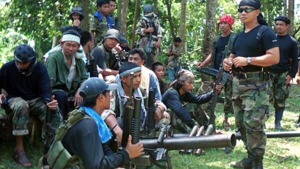 Abu Sayyaf spokesman Abu Sabaya, right foreground, is seen with his band of armed extremists in this undated photo - Sputnik International